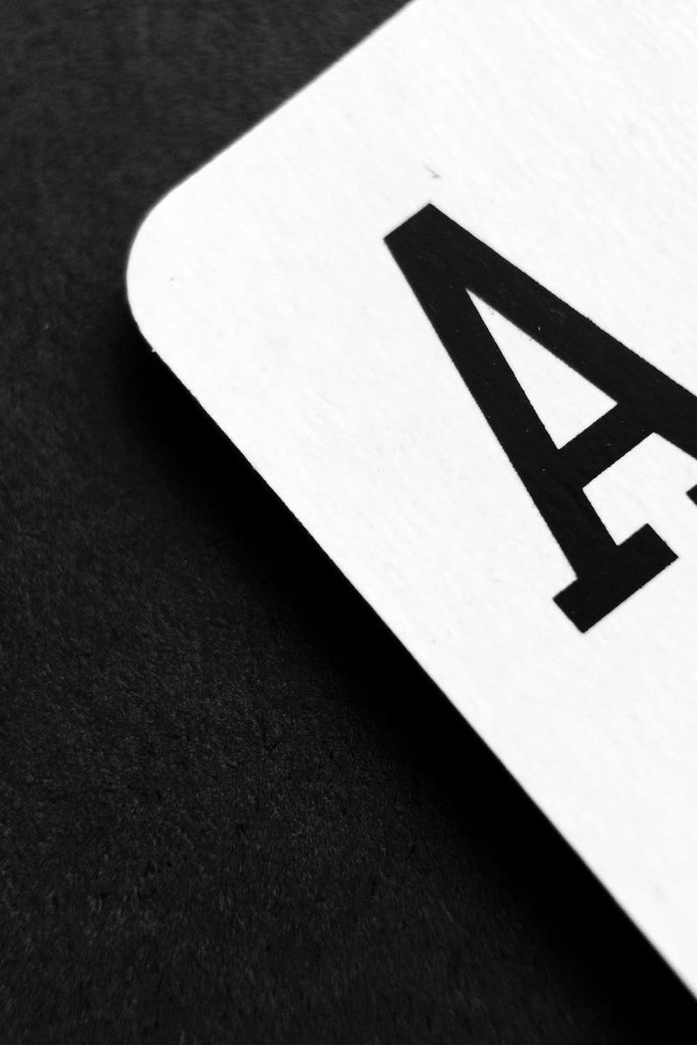  ace_of_spade_playing_card_on_grey_surface