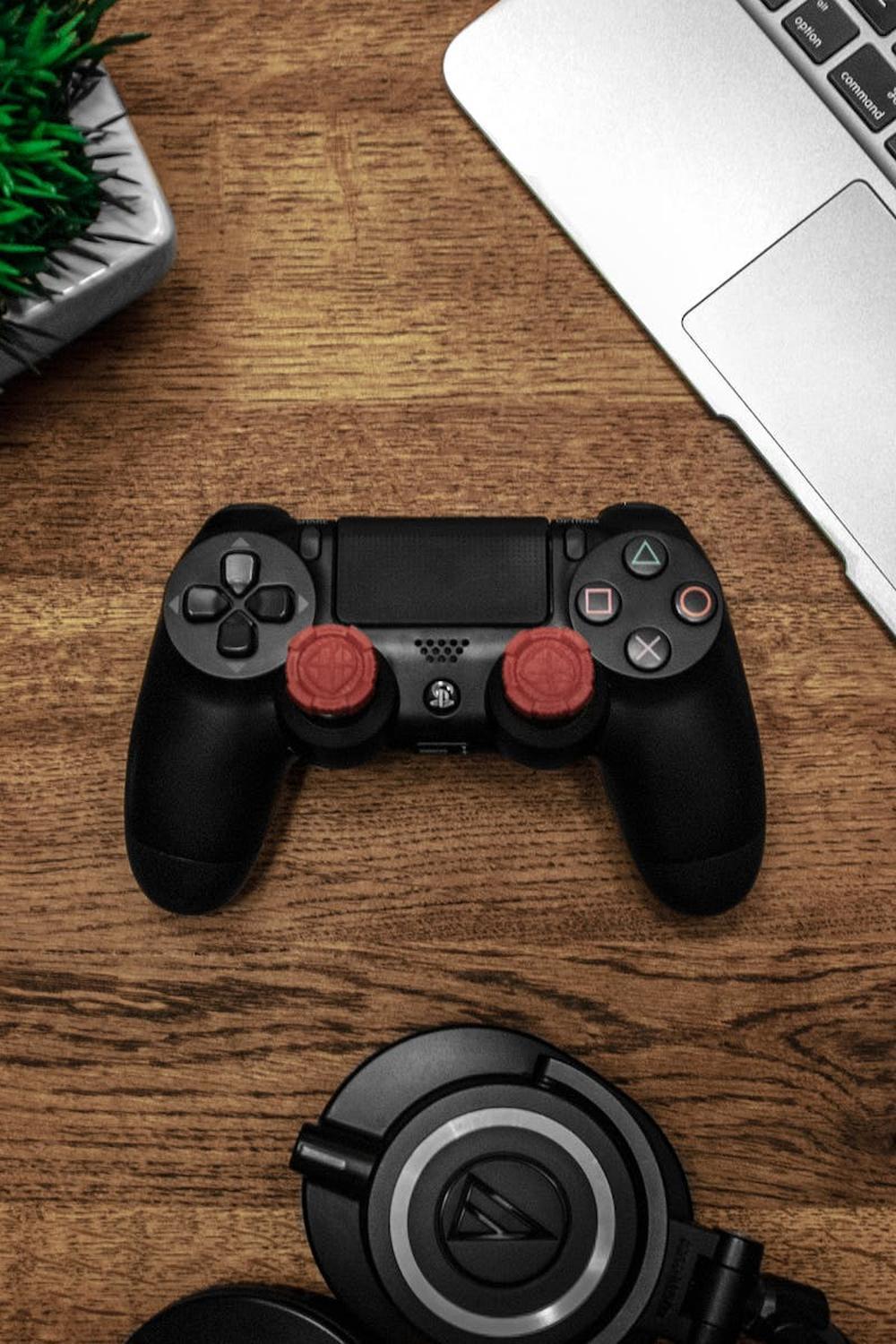 black_game_console_on_wooden_surface