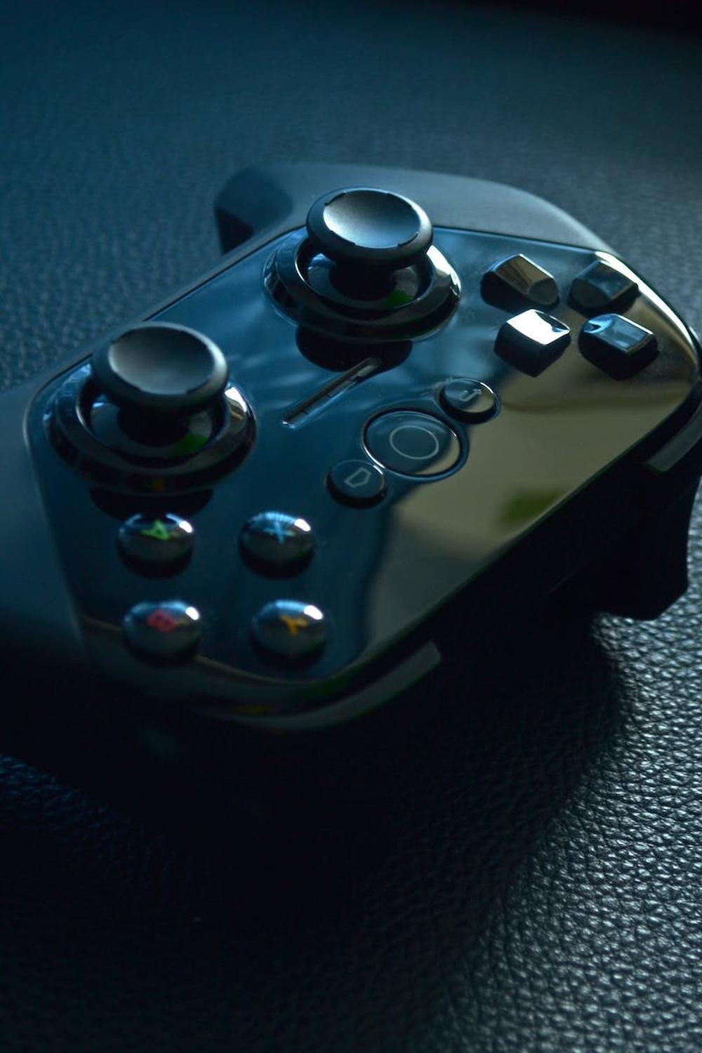 black_wireless_game_controller_on_black_leather