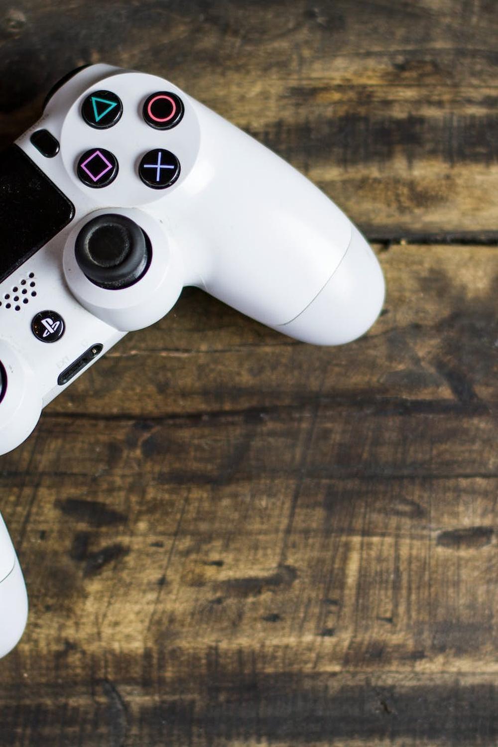 white_gaming_console_on_wooden_surface