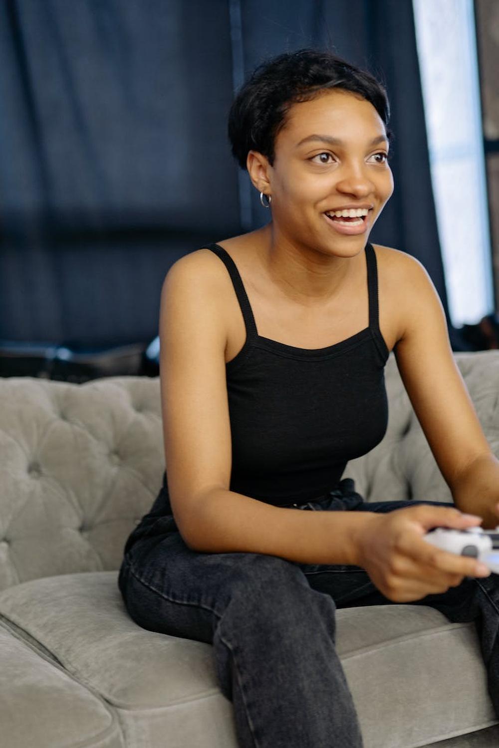 woman_smiles_while_playing_a_game_console